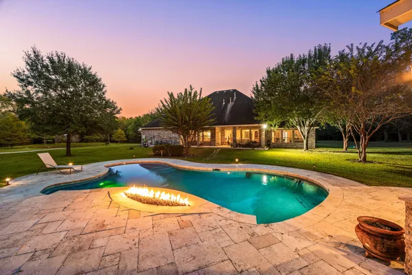 a view of a swimming pool with an outdoor space and seating area