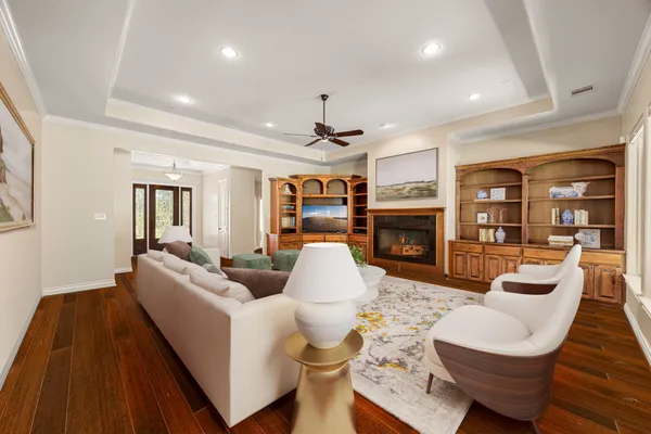 a living room with fireplace furniture and a wooden floor