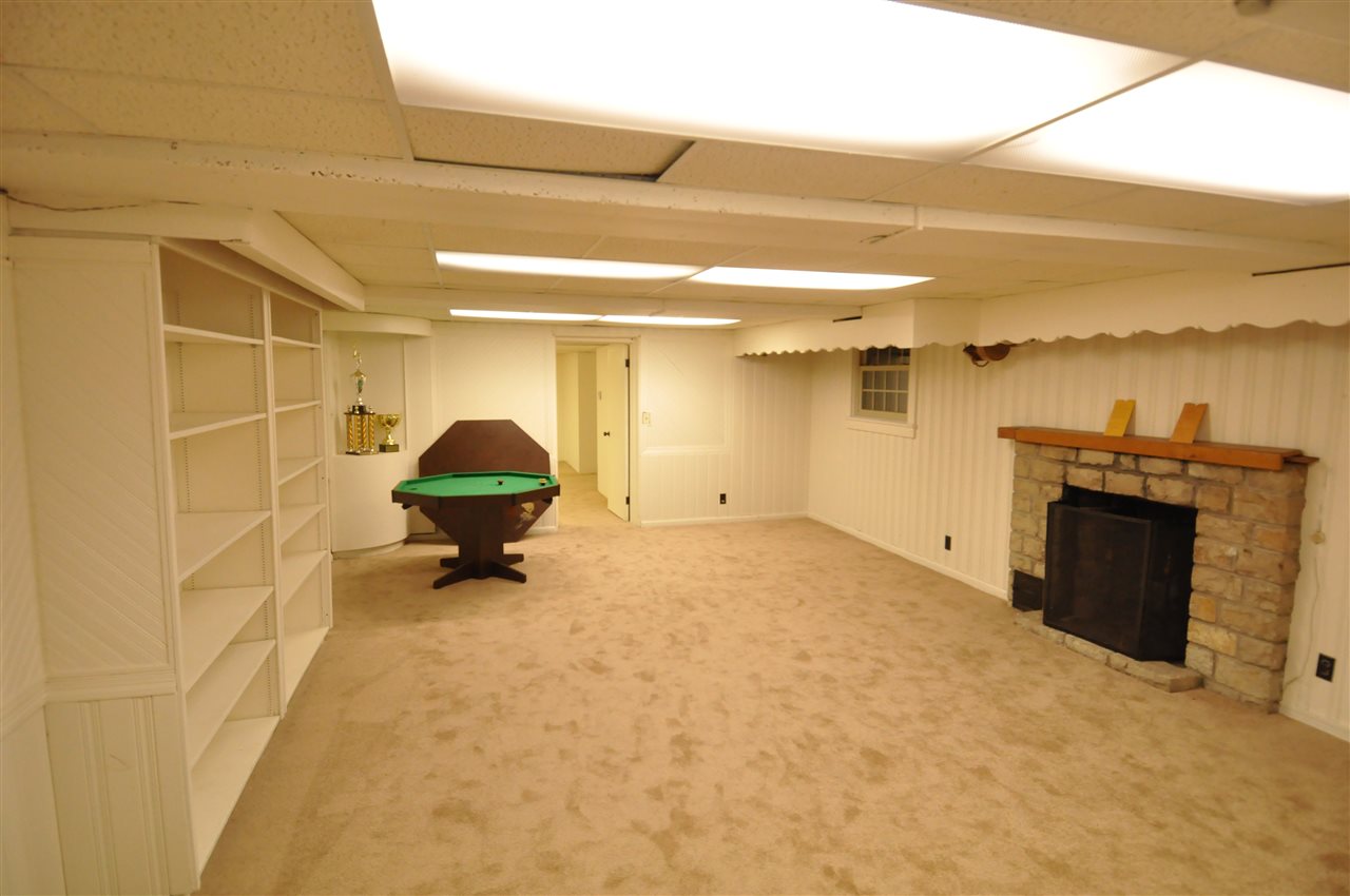 3318 Brookview Road Rockford, IL 61107 - Photo 23 of 30 a room with a washing machine and a fireplace