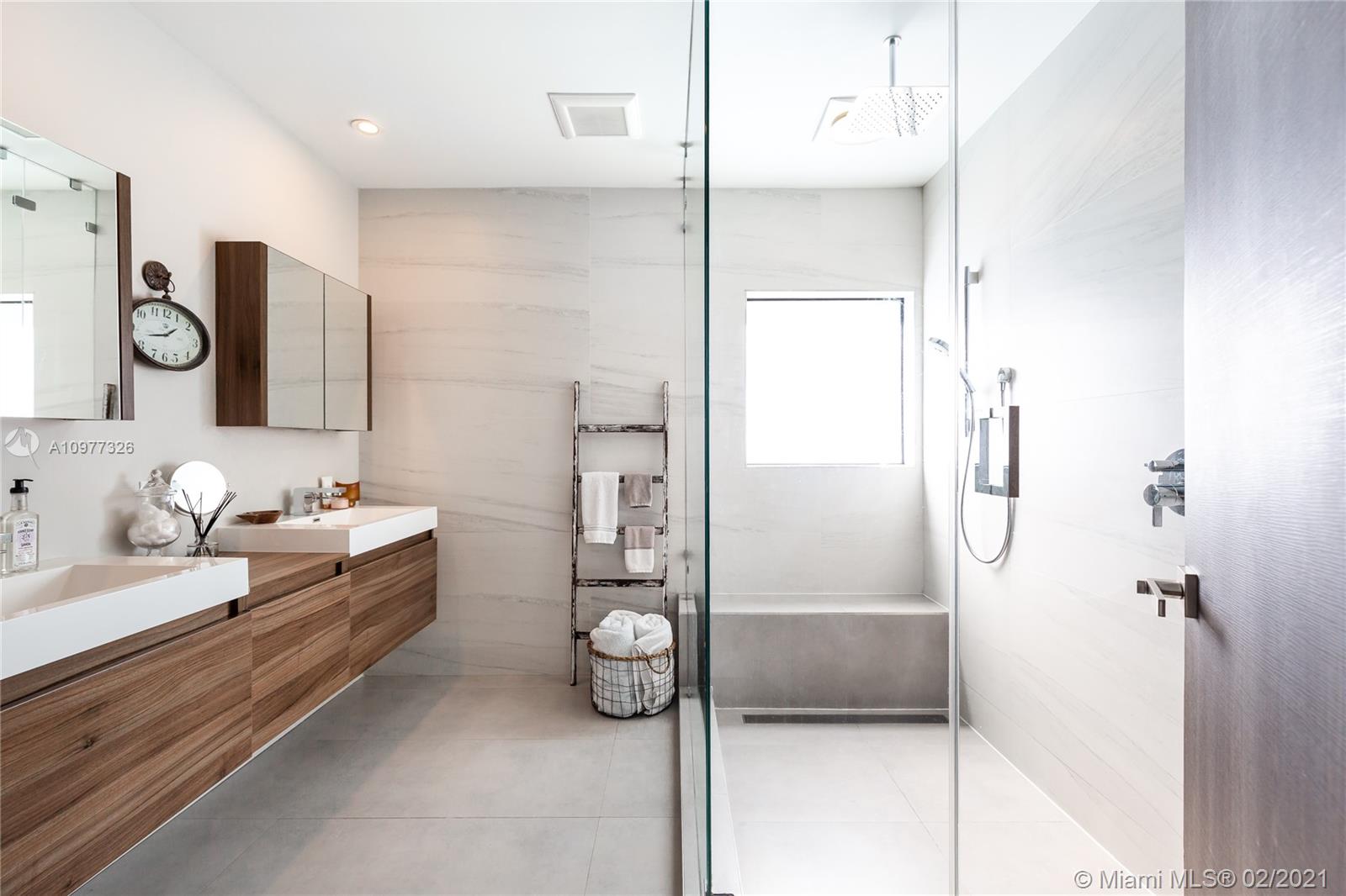 5185 Alton Road Miami Beach, FL 33140 - Photo 15 of 41 a bathroom with a double vanity sink mirror and shower