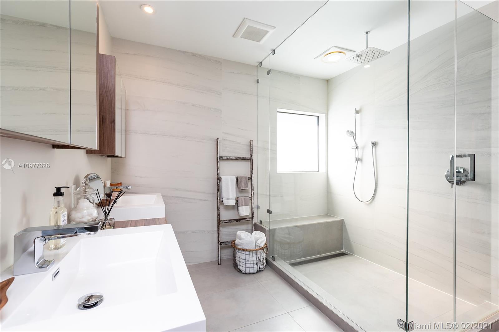 5185 Alton Road Miami Beach, FL 33140 - Photo 16 of 41 a bathroom with a sink a toilet and shower