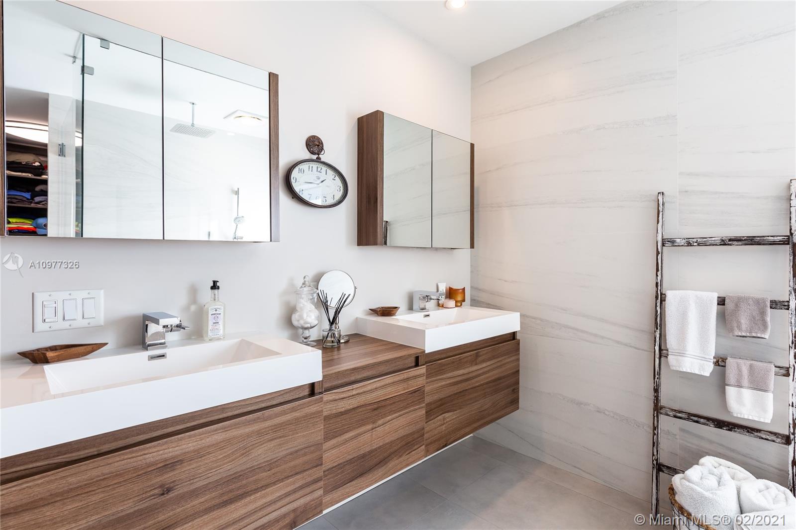5185 Alton Road Miami Beach, FL 33140 - Photo 17 of 41 a bathroom with a sink and a mirror