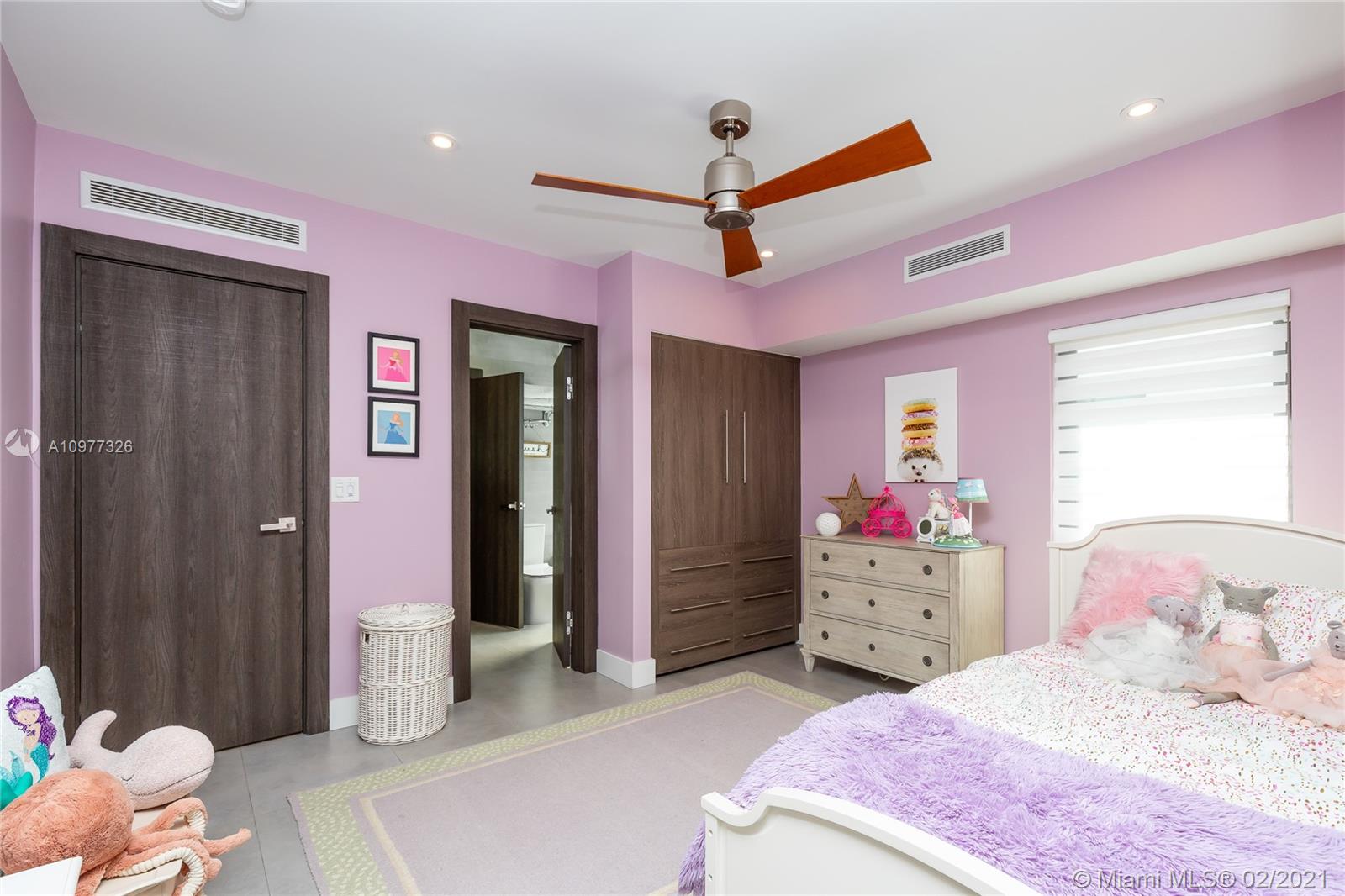5185 Alton Road Miami Beach, FL 33140 - Photo 19 of 41 a bedroom with a bed closet and window