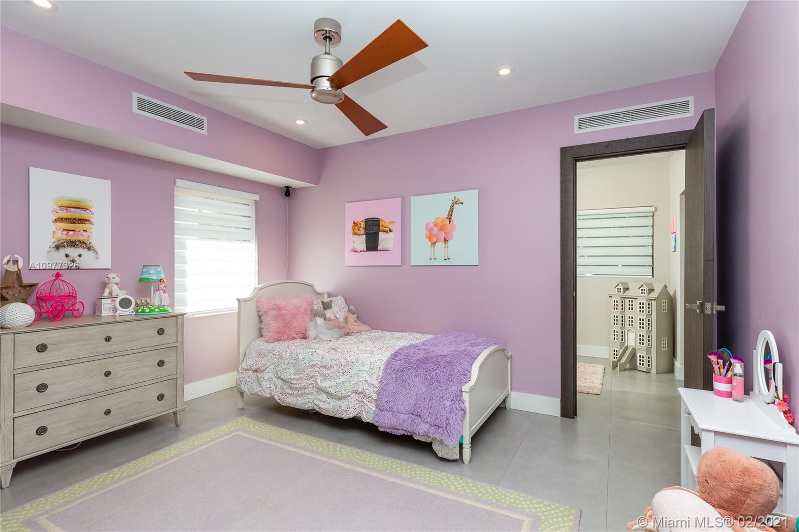 5185 Alton Road Miami Beach, FL 33140 - Photo 20 of 41 a bedroom with a bed and a chandelier