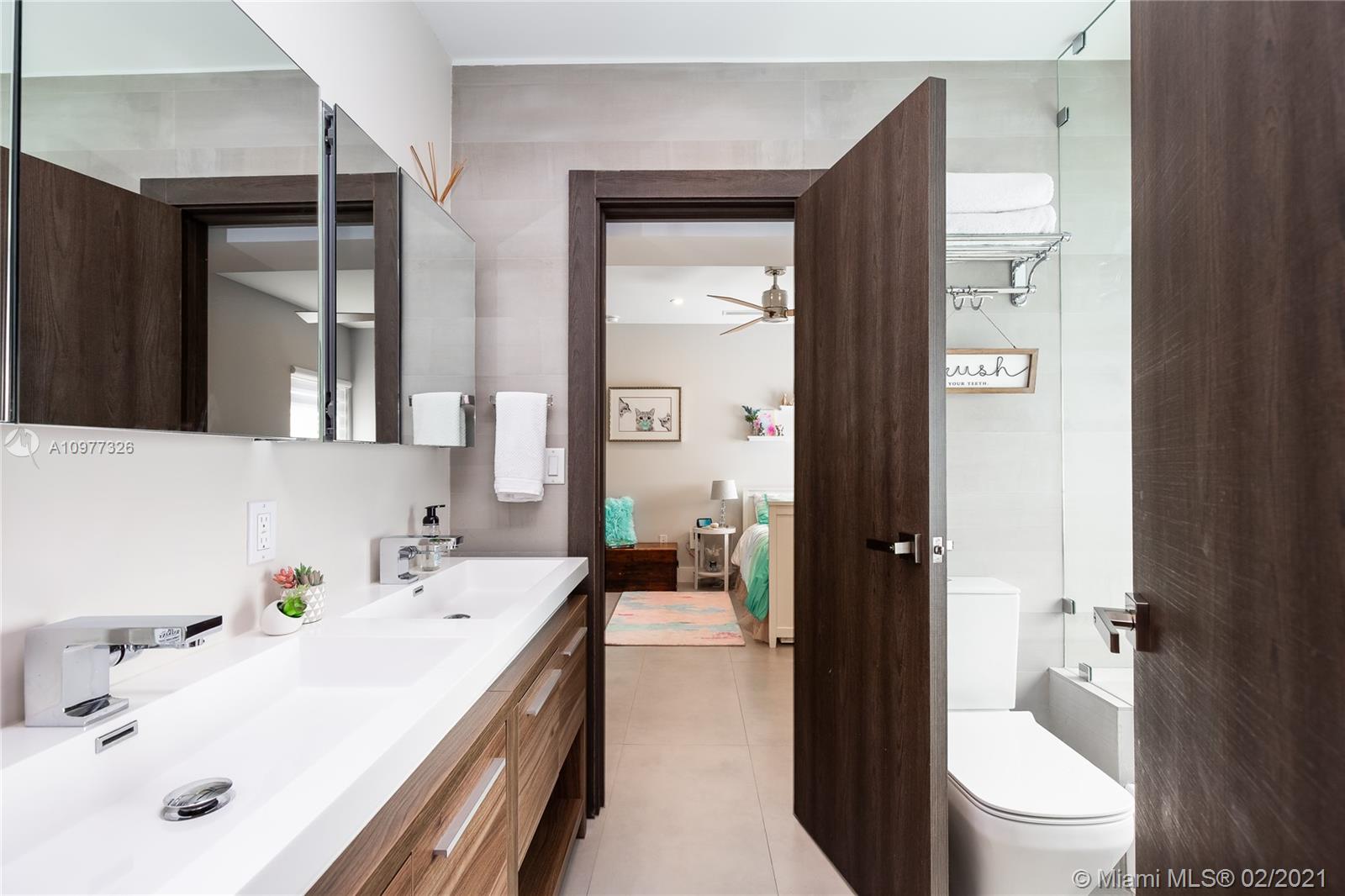 5185 Alton Road Miami Beach, FL 33140 - Photo 21 of 41 a bathroom with a sink a toilet and shower