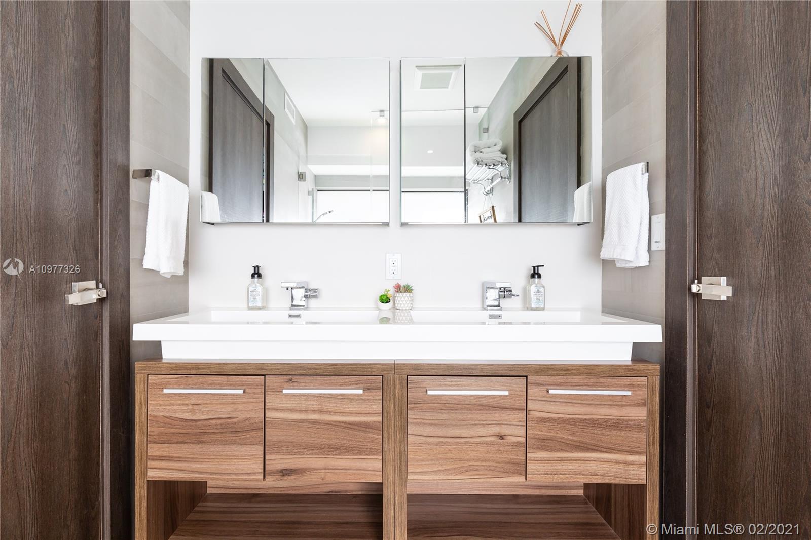 5185 Alton Road Miami Beach, FL 33140 - Photo 23 of 41 a bathroom with a sink and a mirror