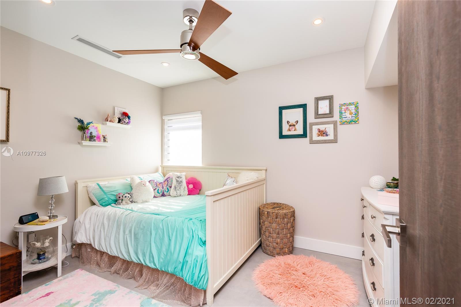 5185 Alton Road Miami Beach, FL 33140 - Photo 24 of 41 a bedroom with a bed and a dresser