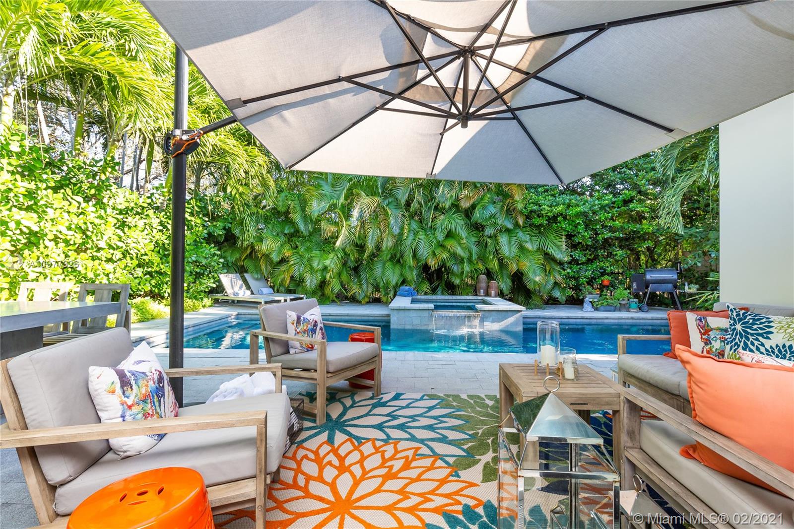 5185 Alton Road Miami Beach, FL 33140 - Photo 28 of 41 a patio with patio a table and chairs under an umbrella
