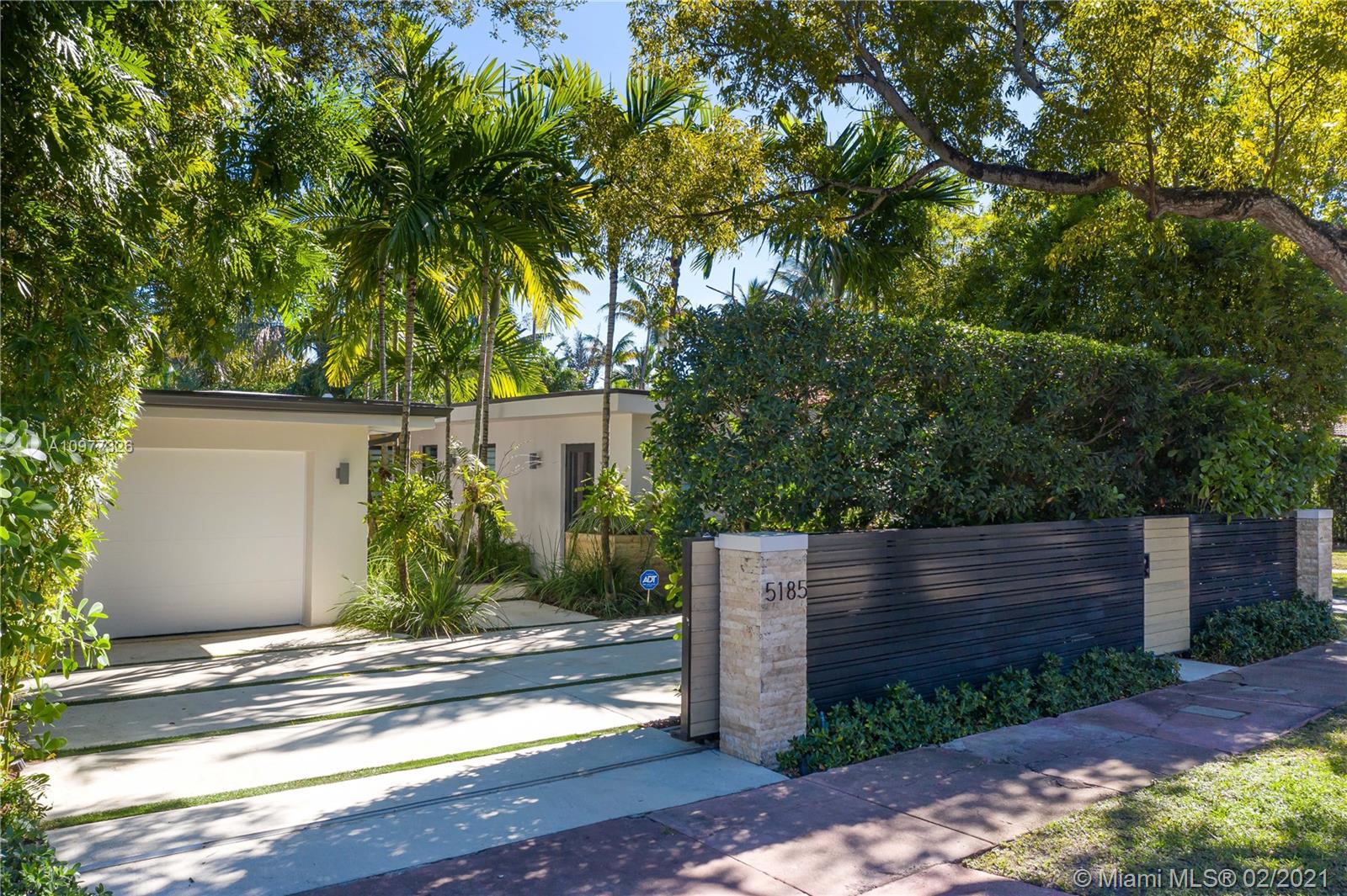 5185 Alton Road Miami Beach, FL 33140 - Photo 36 of 41 a view of a house with a tree in the background