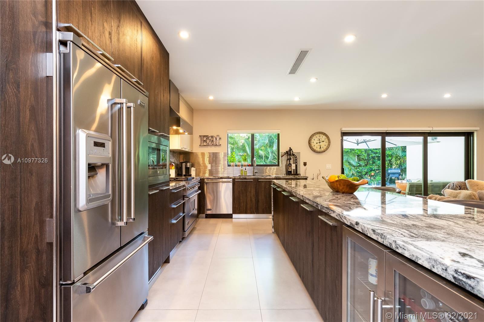 5185 Alton Road Miami Beach, FL 33140 - Photo 9 of 41 a kitchen with lots of counter top space and stainless steel appliances