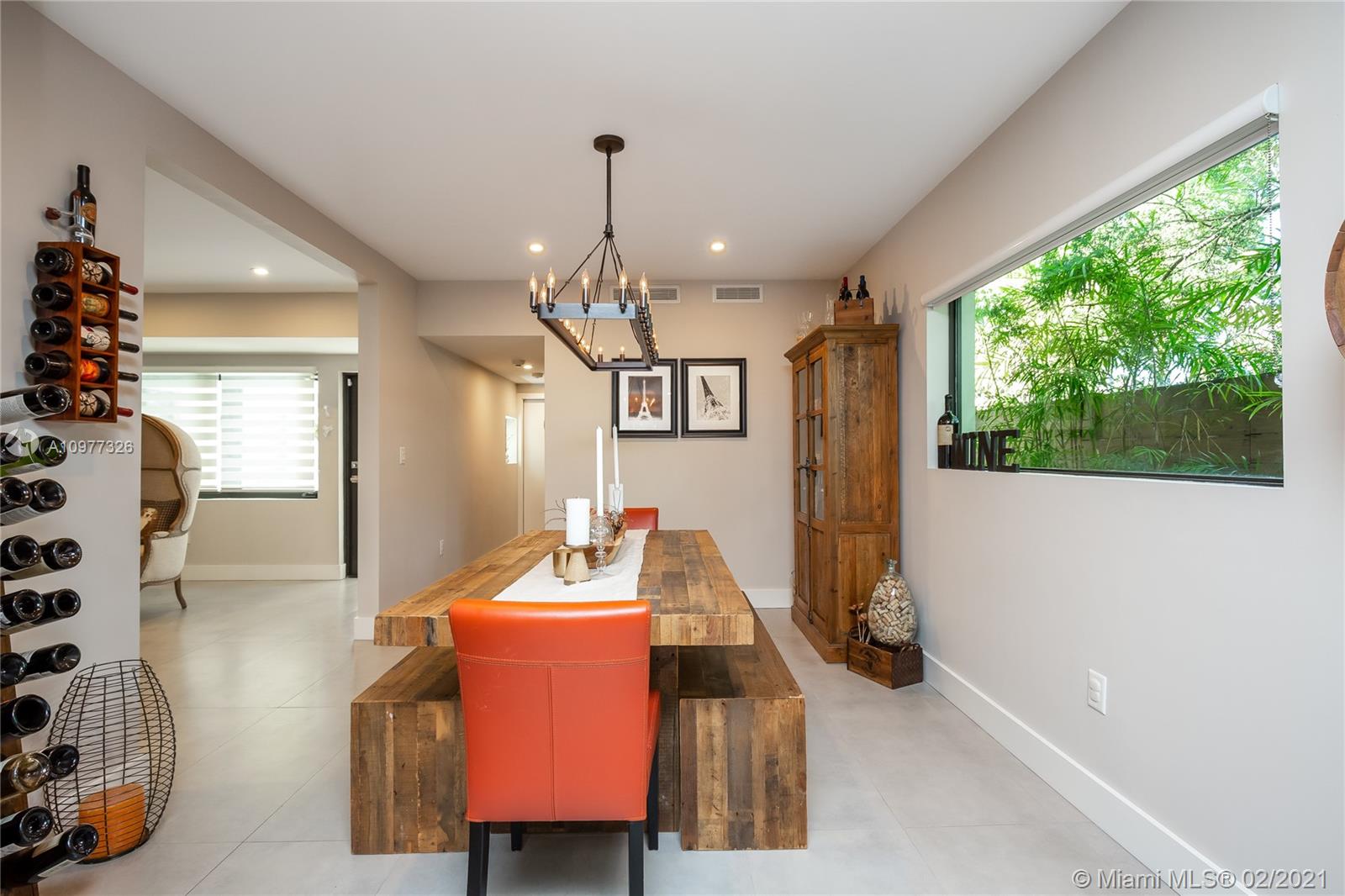 5185 Alton Road Miami Beach, FL 33140 - Photo 10 of 41 a view of a dining room with furniture window and wooden floor
