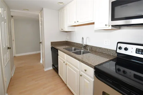 a kitchen with a sink and cabinets