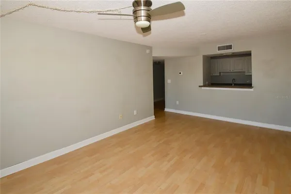 a view of an empty room with wooden floor