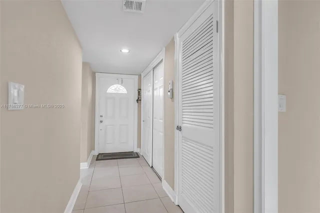 a view of a hallway with wooden shelves