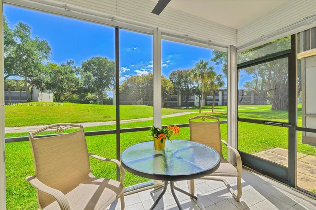 a view of a patio with a table chairs and a backyard