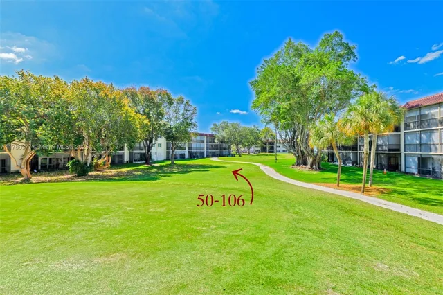 a view of a park with large trees