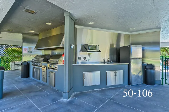 a kitchen with stainless steel appliances a stove a sink and a refrigerator