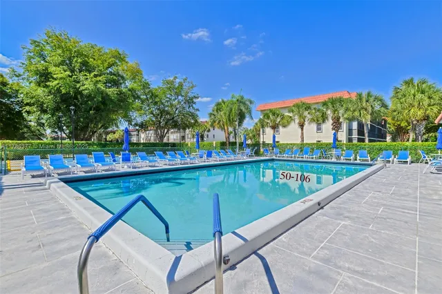 a view of swimming pool with outdoor seating and city view