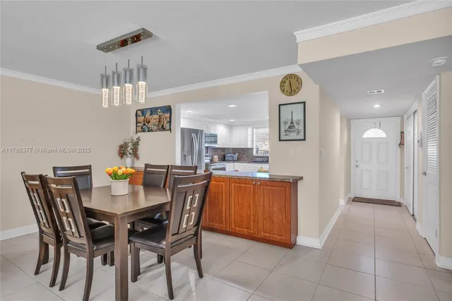 a dining room with a wooden table and chairs