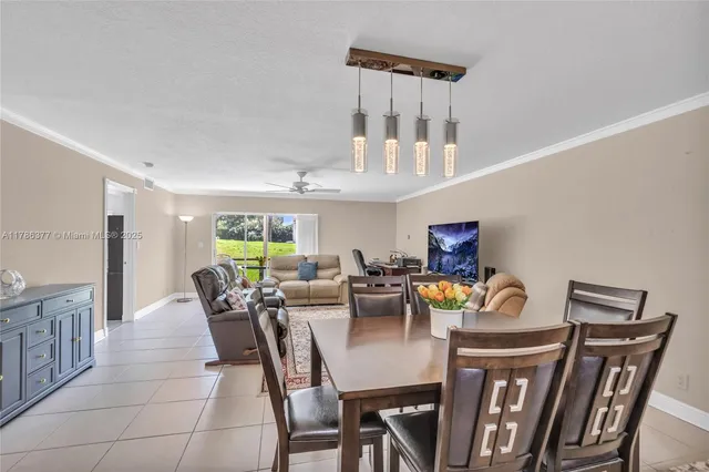a view of a dining room with furniture a chandelier and wooden floor
