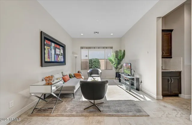 a living room with furniture and a large window