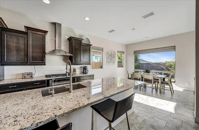 a kitchen with granite countertop a stove and a sink