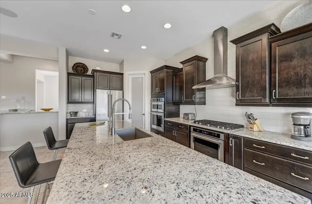 a dining room with furniture and a floor to ceiling window