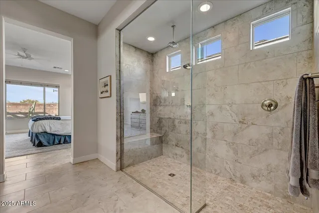 a bedroom with a bed and a flat tv screen on a dresser