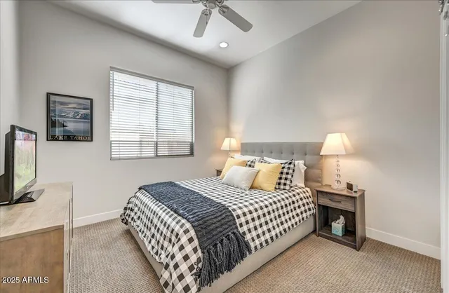 a bathroom with a granite countertop sink a toilet a large mirror and bathtub