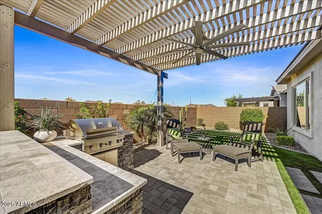 a view of a patio with table and chairs with wooden floor and fence