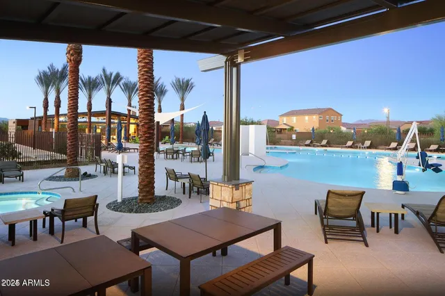a view of a backyard with table and chairs plants
