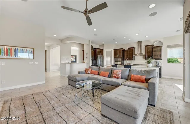 a living room with furniture and kitchen view