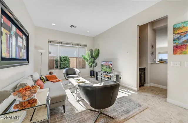 a living room with furniture and a potted plant
