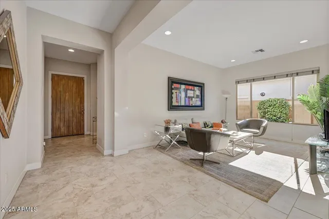 a living room with furniture and a large window
