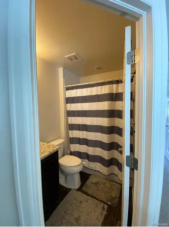 a bedroom with a bed dresser furniture and a window