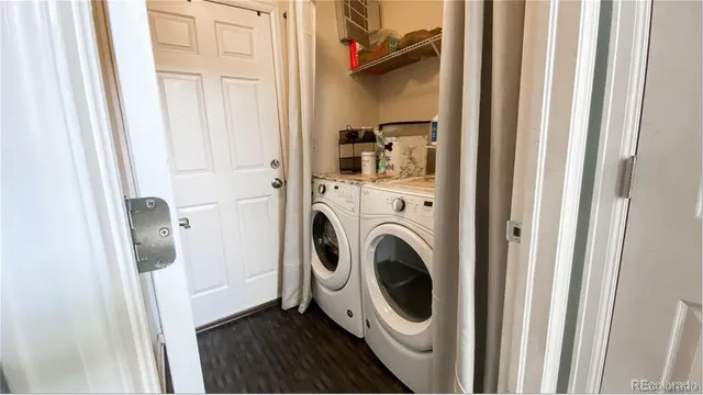 a kitchen with granite countertop a refrigerator a sink a stove a oven a kitchen island and chairs