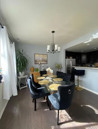 a living room with furniture and a kitchen