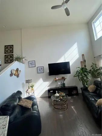 an empty room with a ceiling fan and window