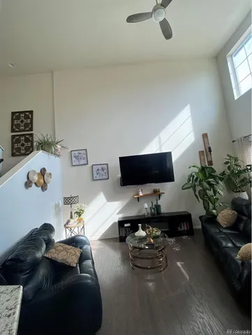 an empty room with a ceiling fan and window