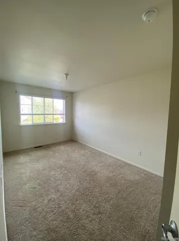 a view of an empty room and a window