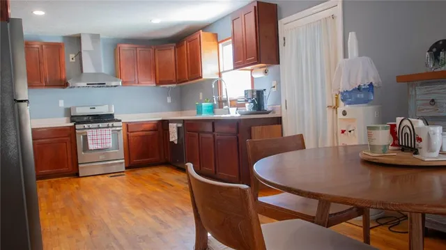 a kitchen with stainless steel appliances granite countertop a stove a sink dishwasher and cabinets