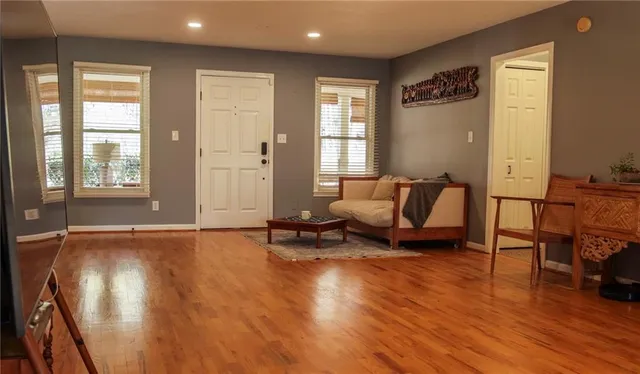 a living room with furniture and a wooden floor