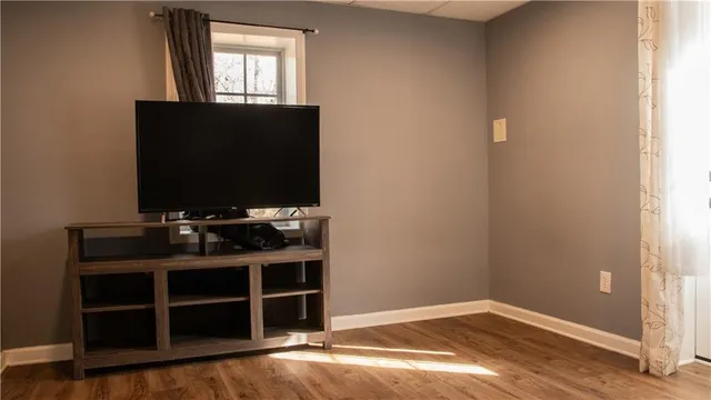 a view of a workspace with furniture and wooden floor