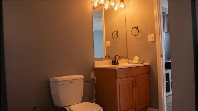 a bathroom with a sink mirror and toilet
