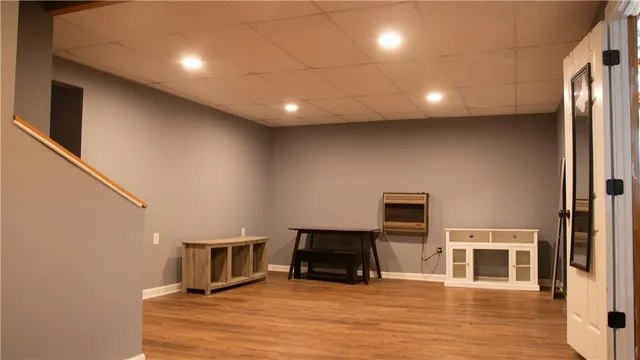 a view of a kitchen with furniture and wooden floor