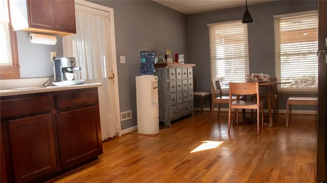a dining room with furniture and wooden floor