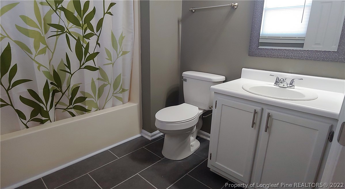 481 Camden Road Raeford, NC 28376 - Photo 16 of 18 a bathroom with a toilet sink and mirror