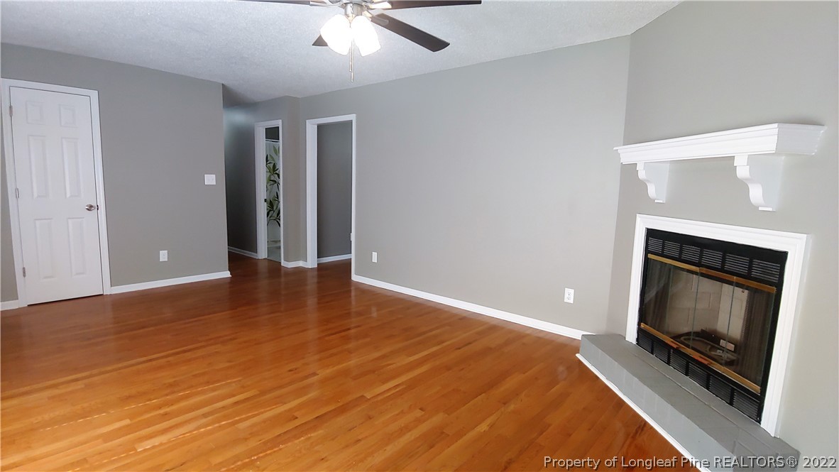 481 Camden Road Raeford, NC 28376 - Photo 3 of 18 a view of an empty room with wooden floor and a fireplace