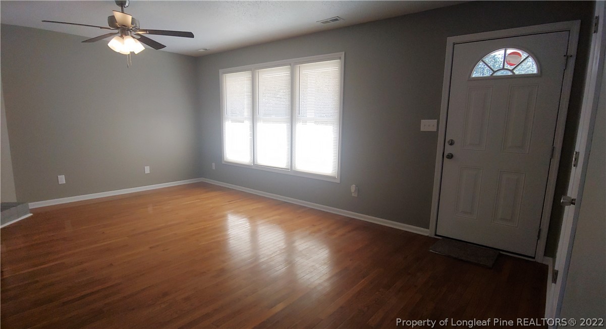481 Camden Road Raeford, NC 28376 - Photo 6 of 18 an empty room with wooden floor closet and windows