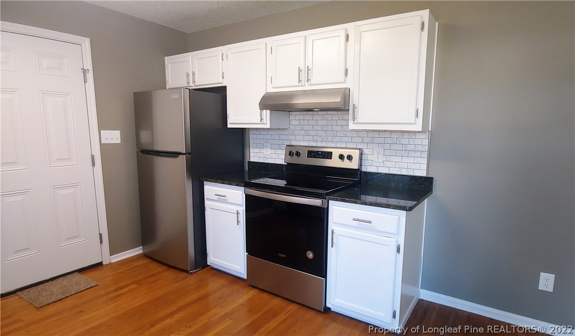 481 Camden Road Raeford, NC 28376 - Photo 7 of 18 a kitchen with a refrigerator stove and cabinets